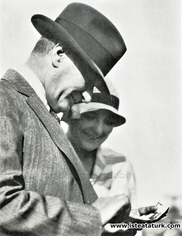 Mustafa Kemal Atatürk examines his previous photographs taken by photographer Cemal Işıksel. (04.07.1929)